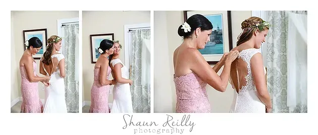 Two women in pink and white dresses embrace in a bright room, with a soft mirrored photo collage.
