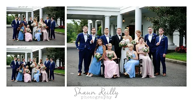 Wedding party posing outdoors in front of a white-columned building, with a bride in a pink dress in front.