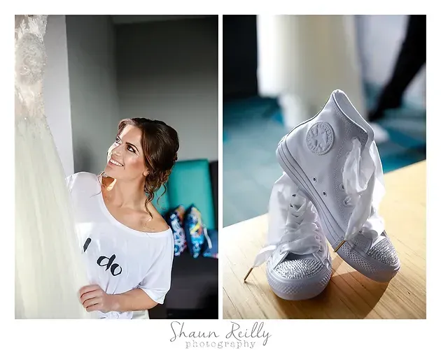 Bride smiling at white wedding boots and dress details indoors