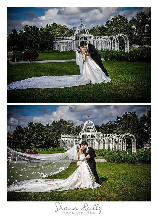 Bride and groom pose in a white dress and black suit on a green lawn with a decorative arbor.