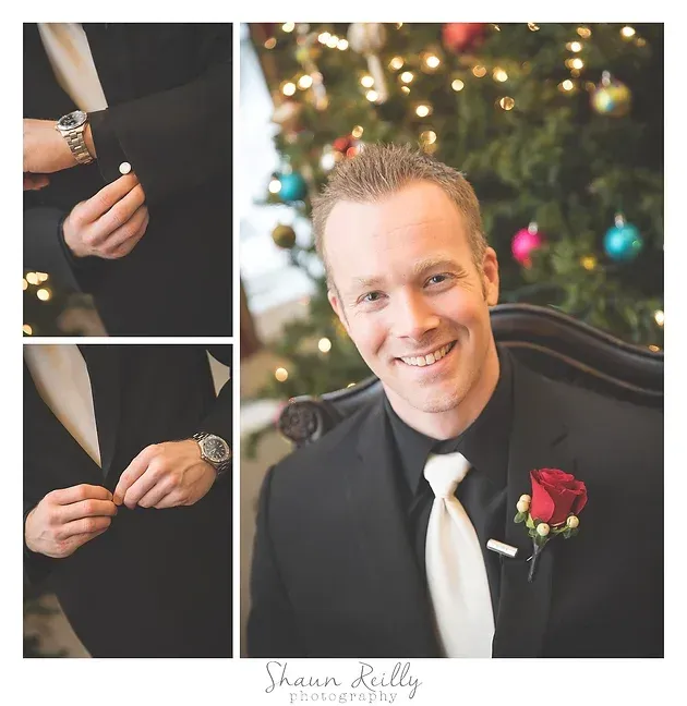 Smiling man in black suit adjusting cufflinks, with close-up suit details beside a decorated Christmas tree
