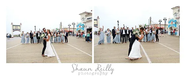Bride and groom walking on a wooden pier, with guests watching in the background