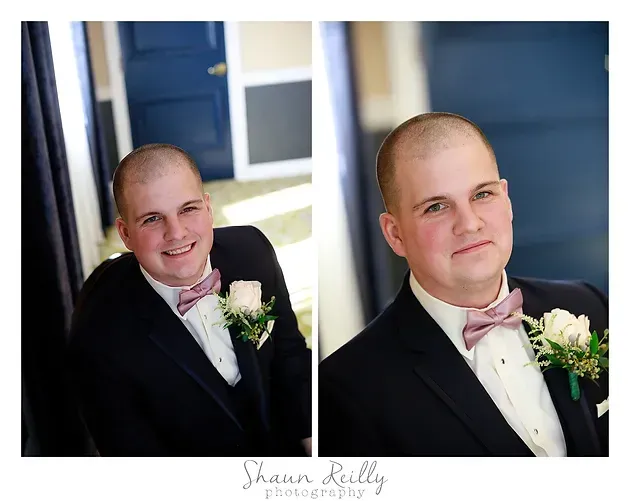 Portrait of a smiling man in a black suit and pink bow tie, holding a white boutonniere