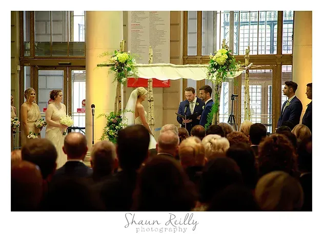 Wedding ceremony in a church, with the bride and groom standing at the altar
