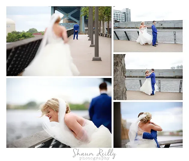 Wedding couple posing by a waterfront railing, with a bride in a white dress and groom in a blue suit.