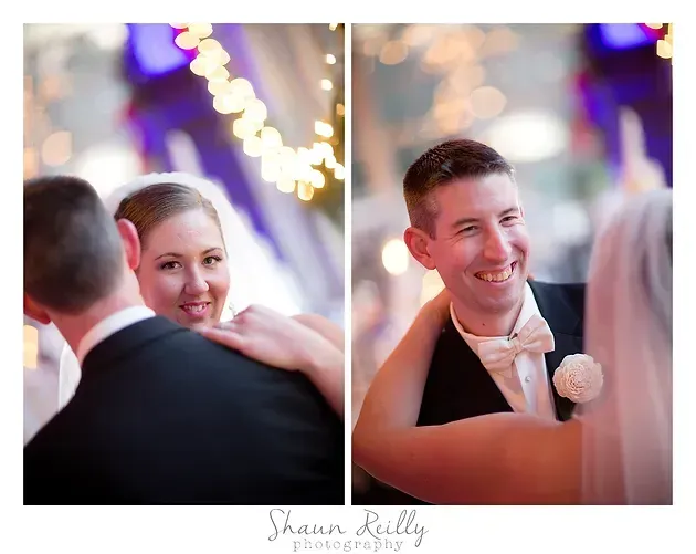 Smiling couple dancing at a wedding, with warm string lights in the background.