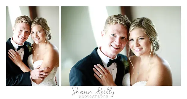 Couple in formal attire smiling and posing with champagne flutes in a bright studio portrait