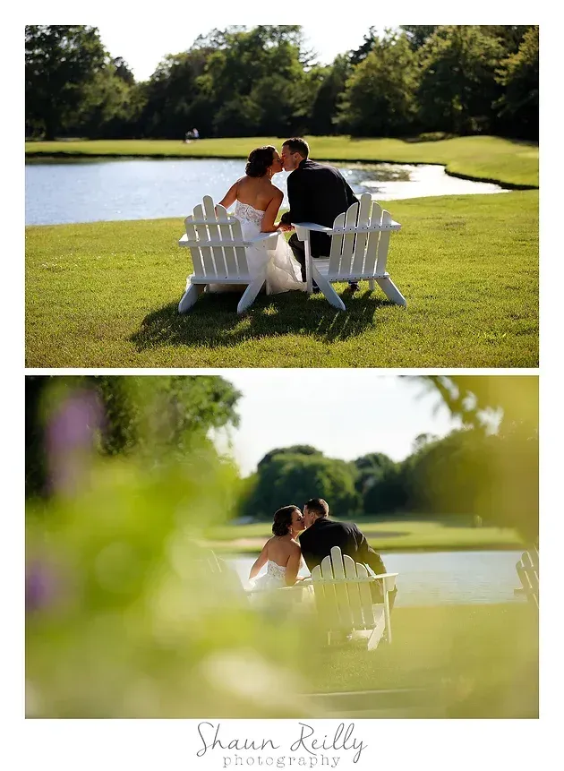 Couple seated in white chairs by a pond on a sunny lawn, with a soft blurred foreground view.