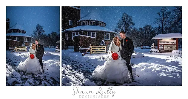 Bride and groom pose in snowy yard in front of a round house at dusk
