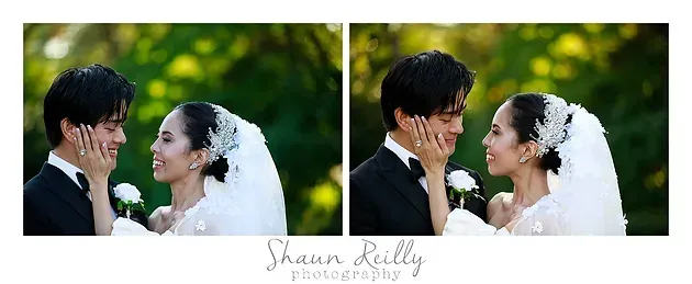 Bride and groom smiling at each other in a green outdoor wedding scene