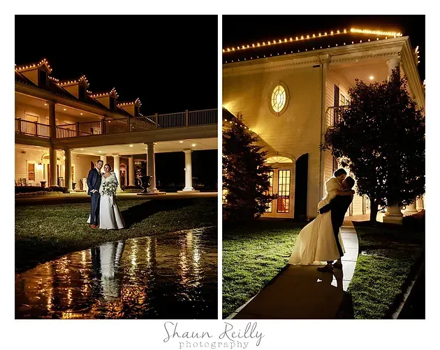 Wedding couple dancing at night outside a warmly lit mansion, reflected in wet pavement