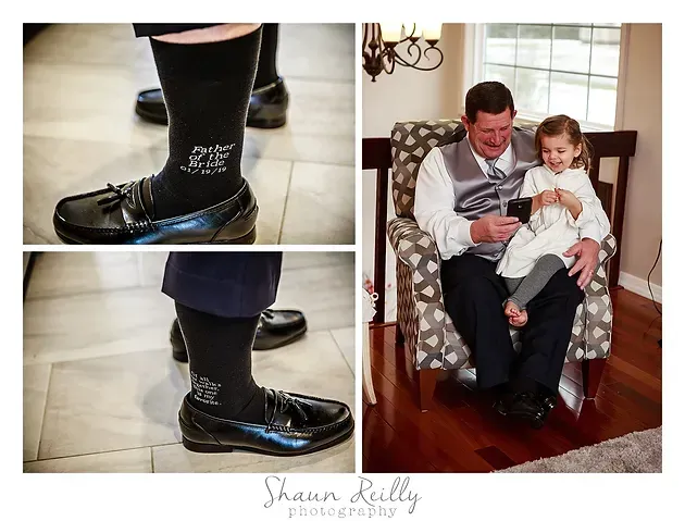 Man in dress shoes and black socks holds a child on his lap in a cozy living room; close-up shoe detail inset.