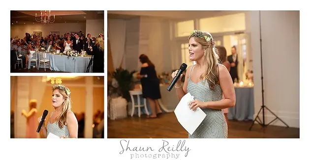 Bride giving a speech at a wedding reception, holding a microphone and note cards in a softly lit hall