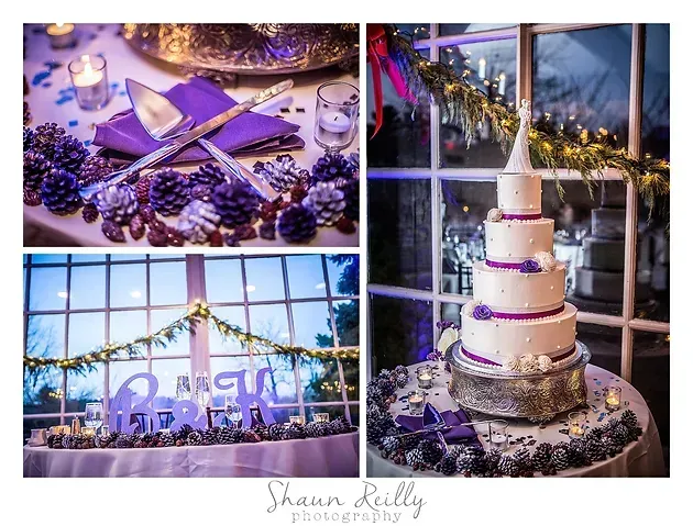 Purple-themed wedding dessert table with a white tiered cake, grapes, and string lights at dusk