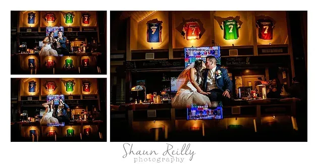 Couple seated in a warmly lit bar, surrounded by glowing jersey displays and colorful neon decor.