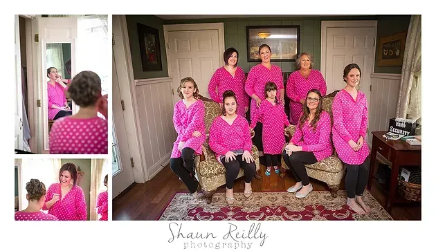 Group portrait of seven people in matching pink tops, seated and standing in a living room
