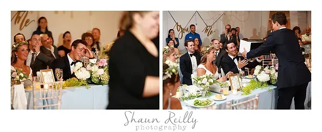 Wedding guests seated at a decorated table as a man gives a speech at the reception
