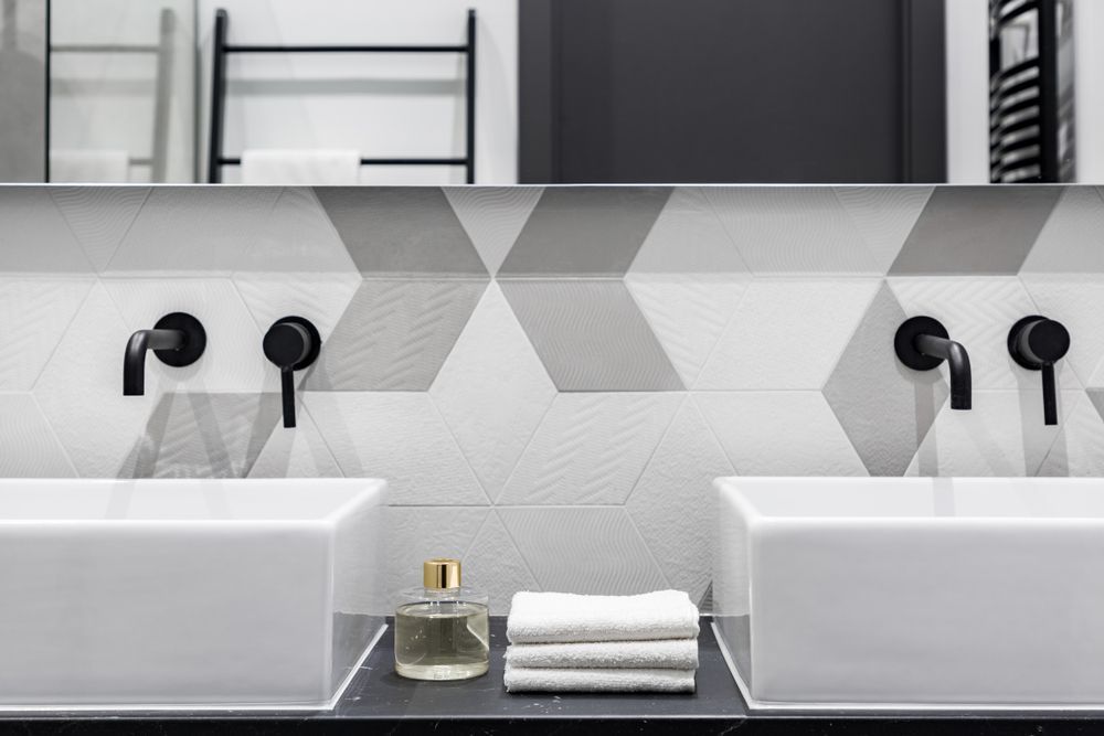 A Bathroom With Two Sinks and a Mirror — Approved Plumbing Service in River Heads, QLD