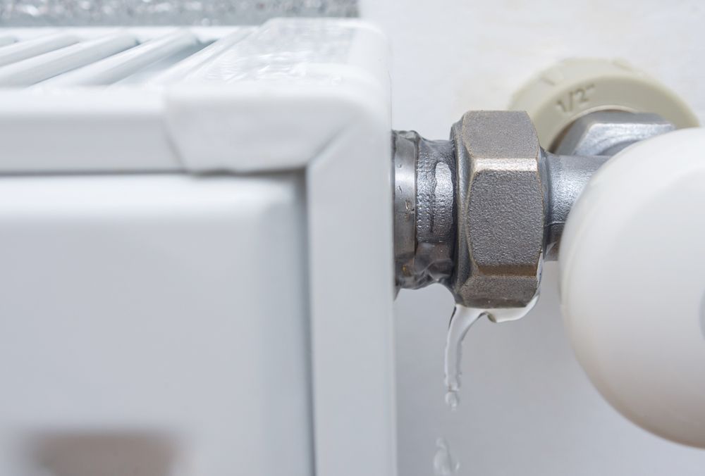A Close Up of a Radiator With Water Leaking Out of It — Approved Plumbing Service in Howard, QLD