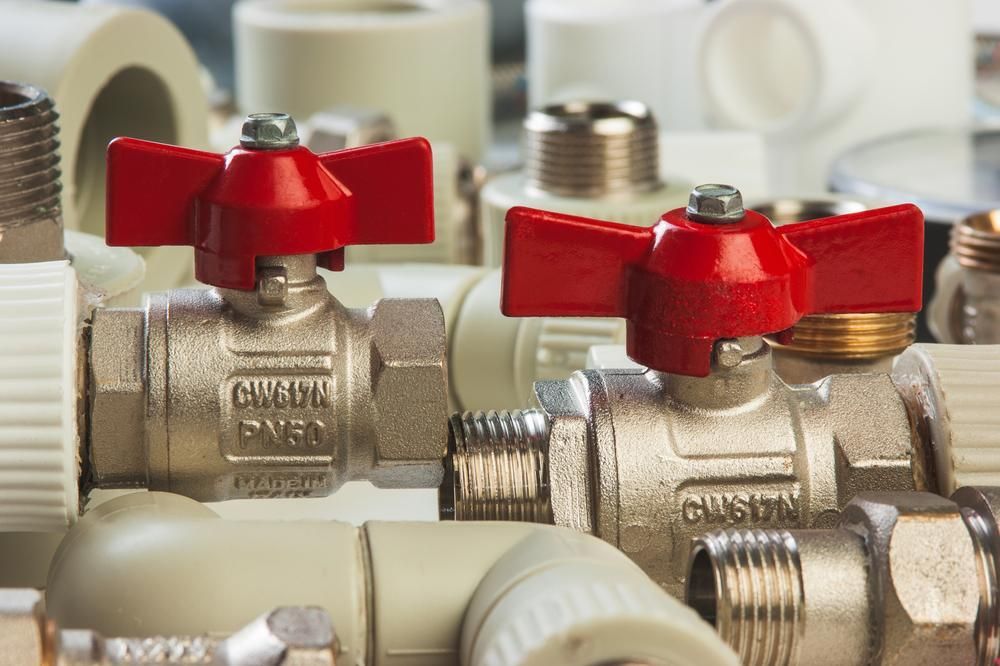 Bunch of Pipes and Valves With Red Handles — Approved Plumbing Service in Burrum Heads, QLD