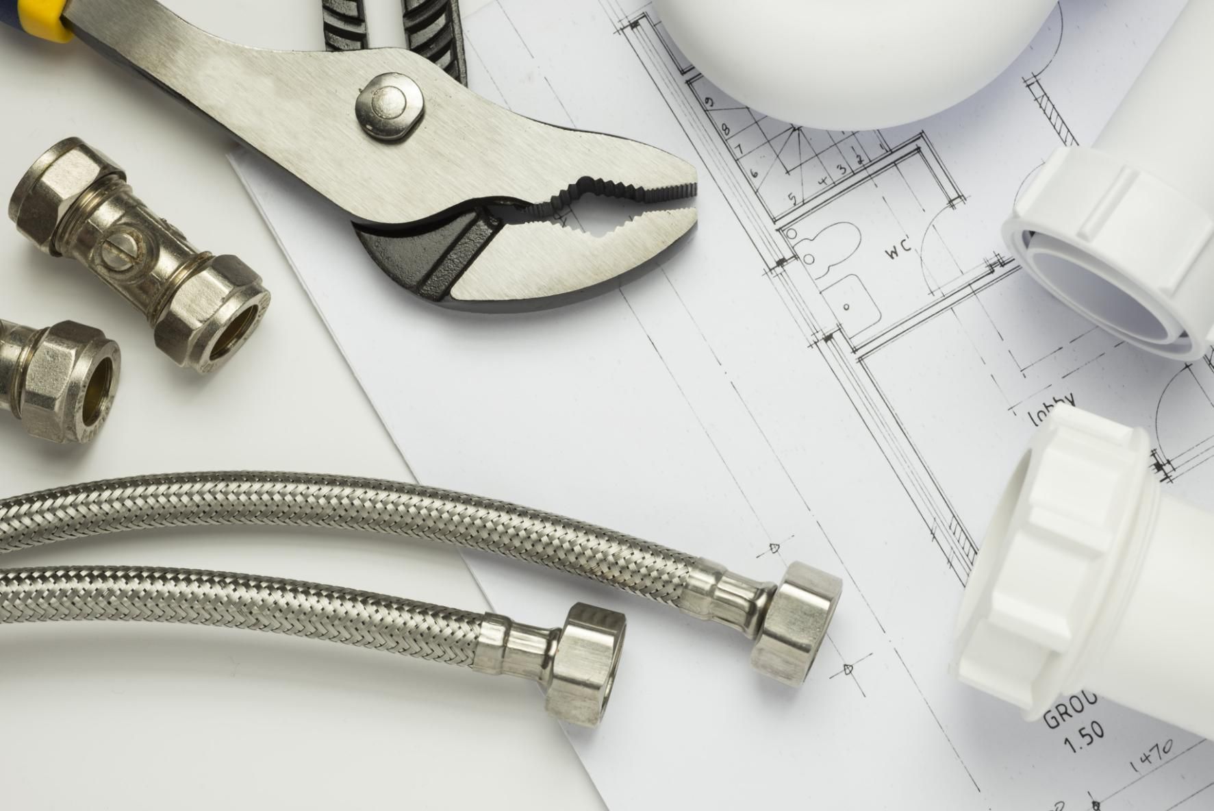 Pair of Pliers Sitting on Top of a Blueprint — Approved Plumbing Service in Woolner, NT
