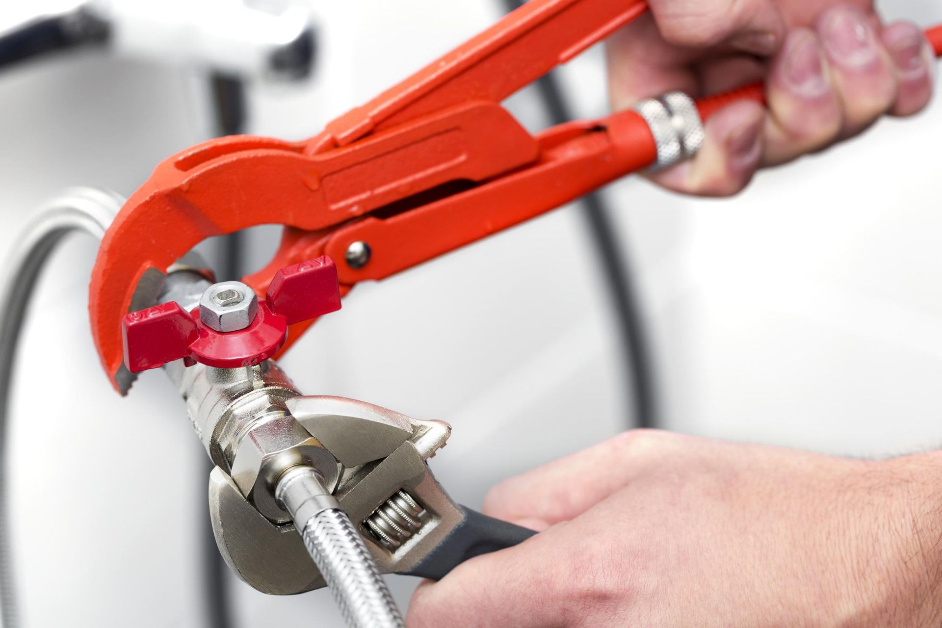 Person is Working on a Pipe With a Wrench — Approved Plumbing Service in Casuarina, NT