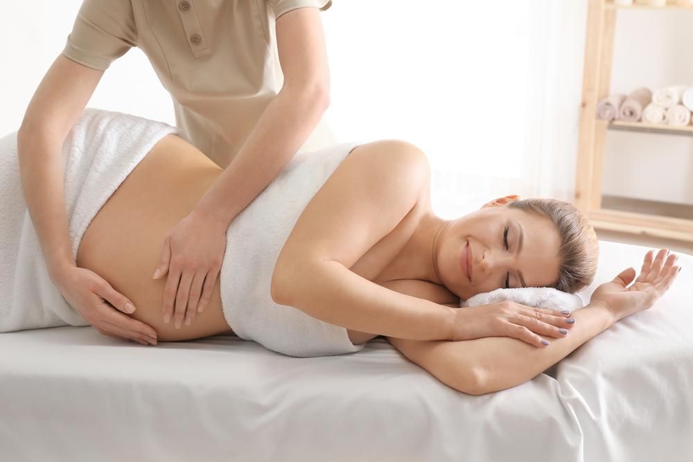 A Pregnant Woman Is Getting a Massage at A Spa — Align Health Therapies in Woonona, NSW