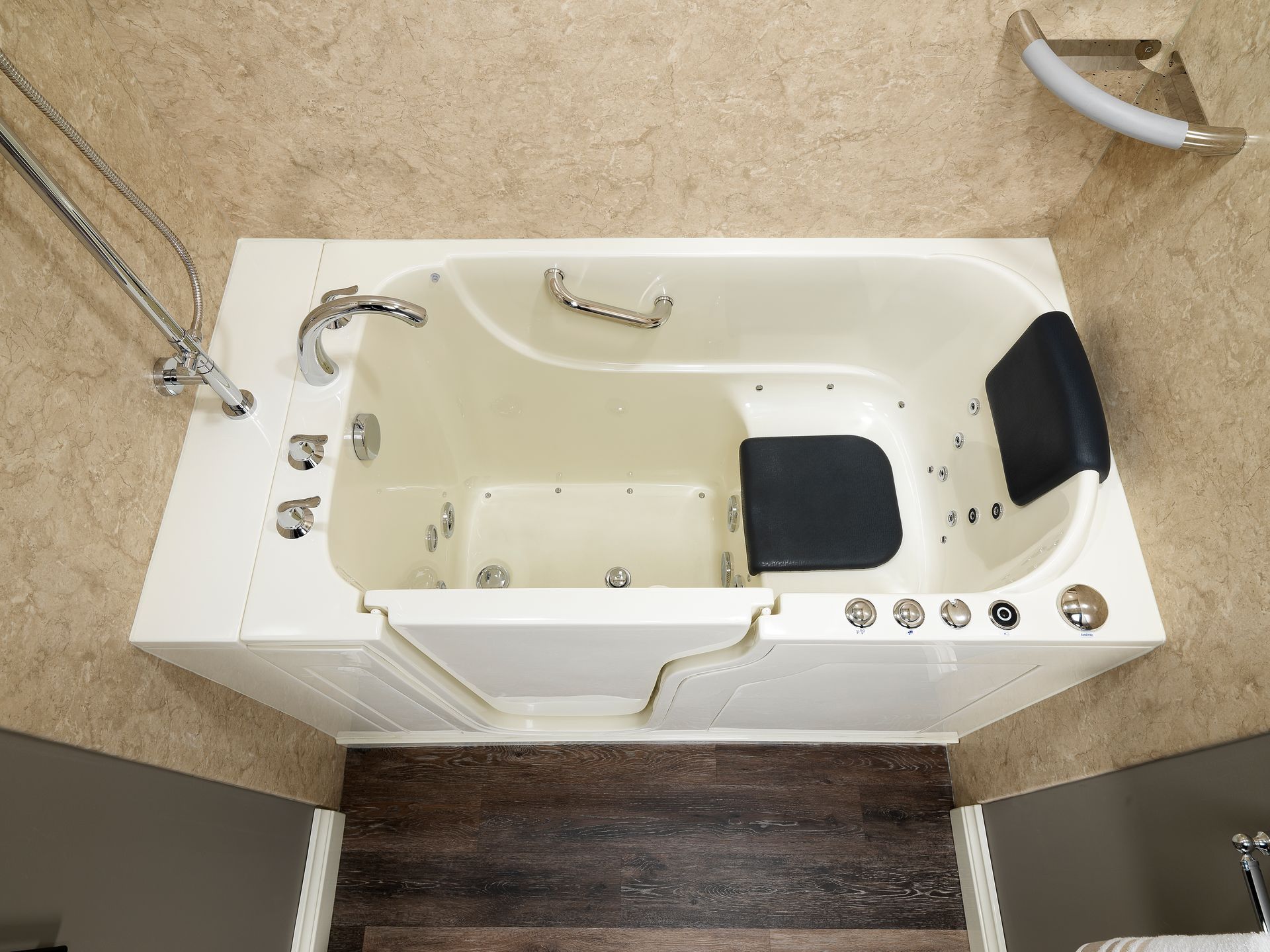 Walk-in bathtub with safety features: white, installed in bathroom with wooden floor.