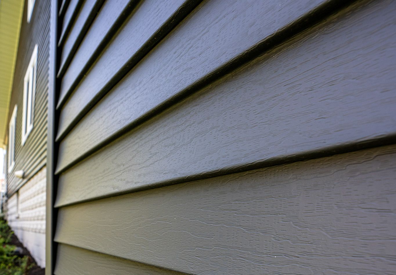 Gray siding on a building's exterior, angled perspective.