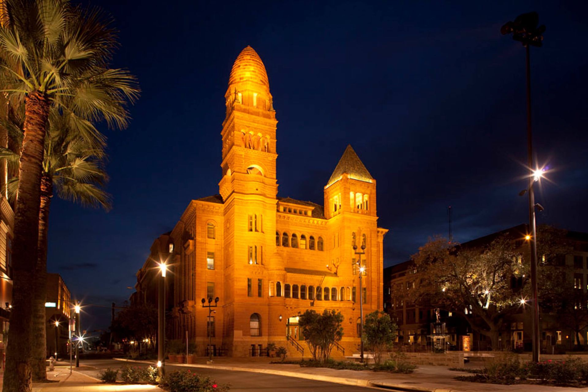 A large building with a clock tower is lit up at night