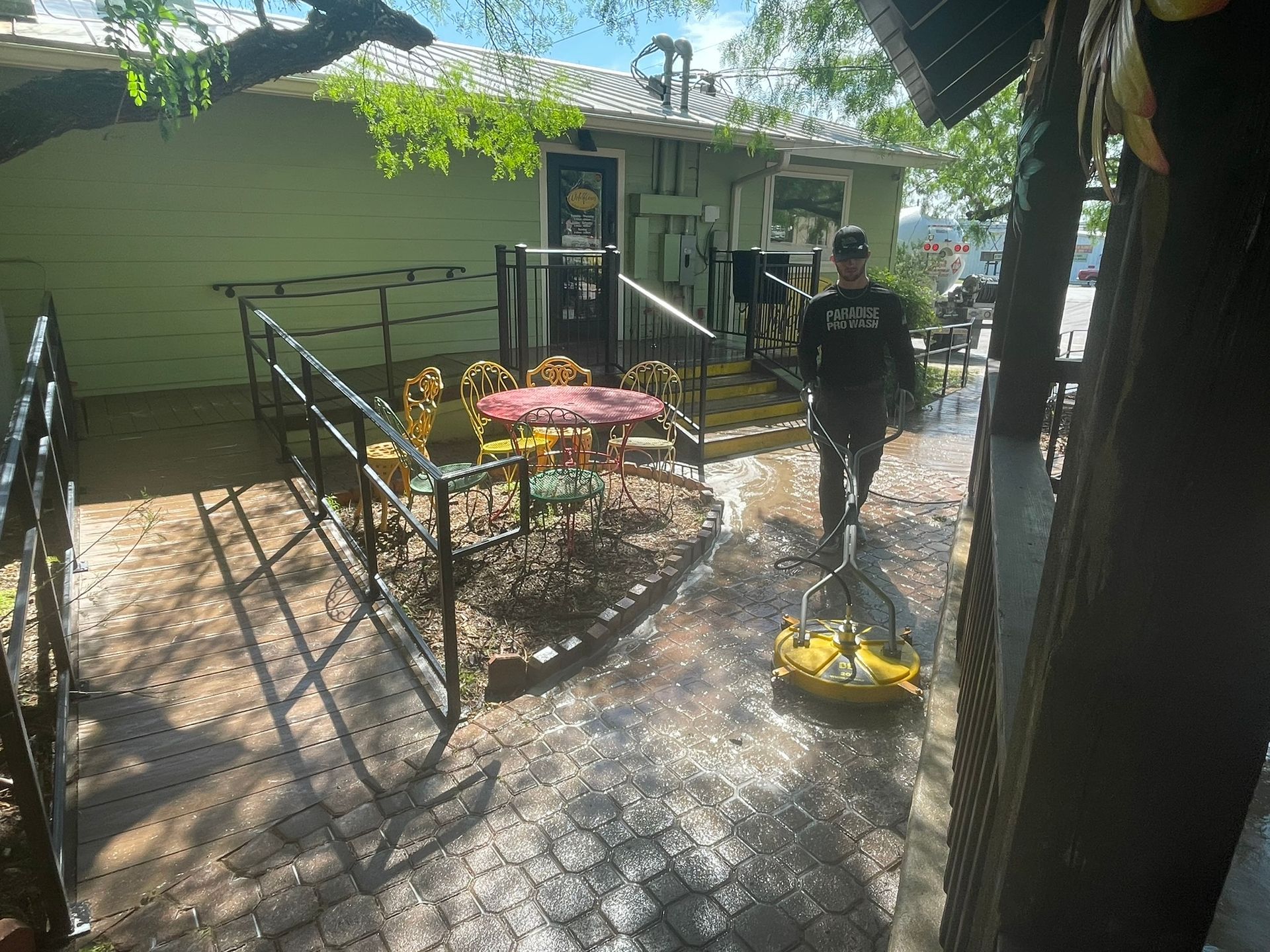 A man is cleaning a patio with a pressure washer in Canyon Lake, TX.