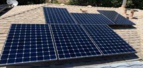 A bunch of solar panels are sitting on top of a roof.