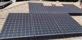 A bunch of solar panels are sitting on top of a roof.