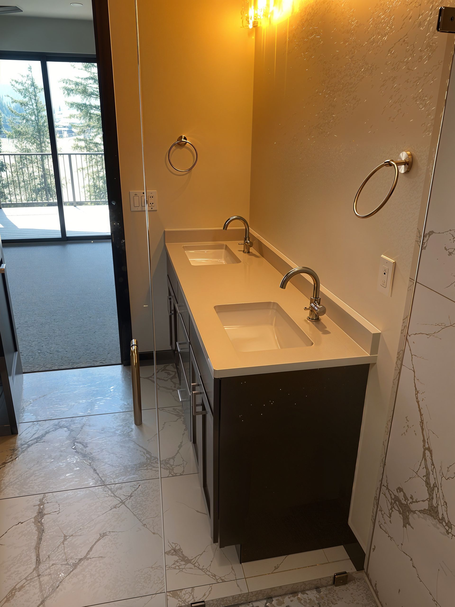 Modern accessible bathroom with double sinks, wall mirrors, grab bars, and tiled floor.