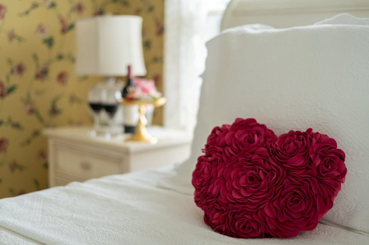 Bed and night stand with flowers