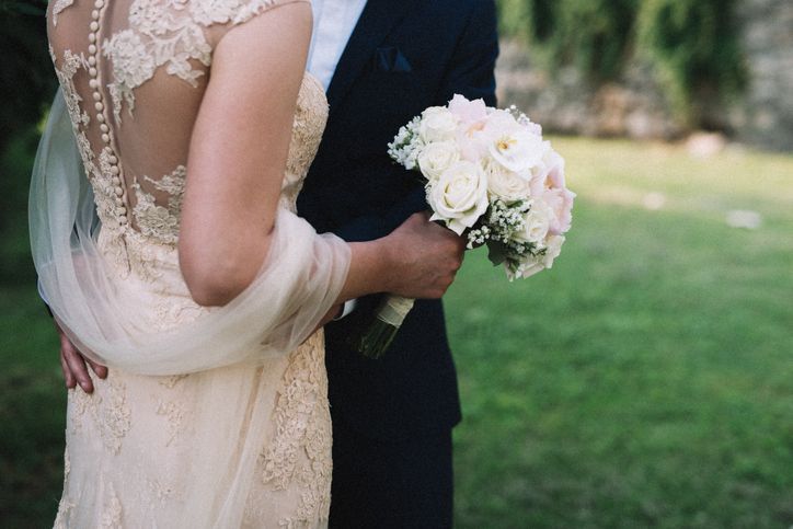 Wedding couple with bride holding flowers