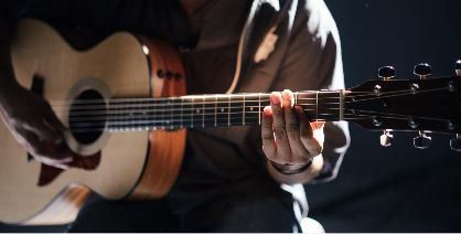 Person playing a guitar