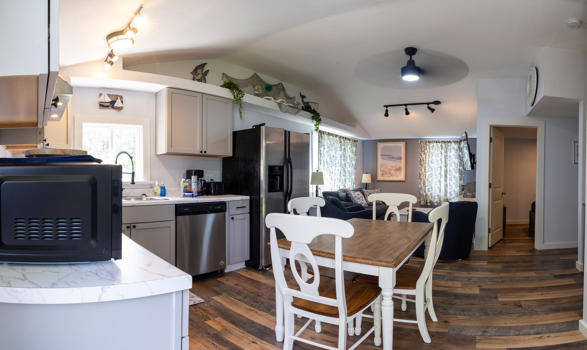 A kitchen with a table and chairs and a microwave