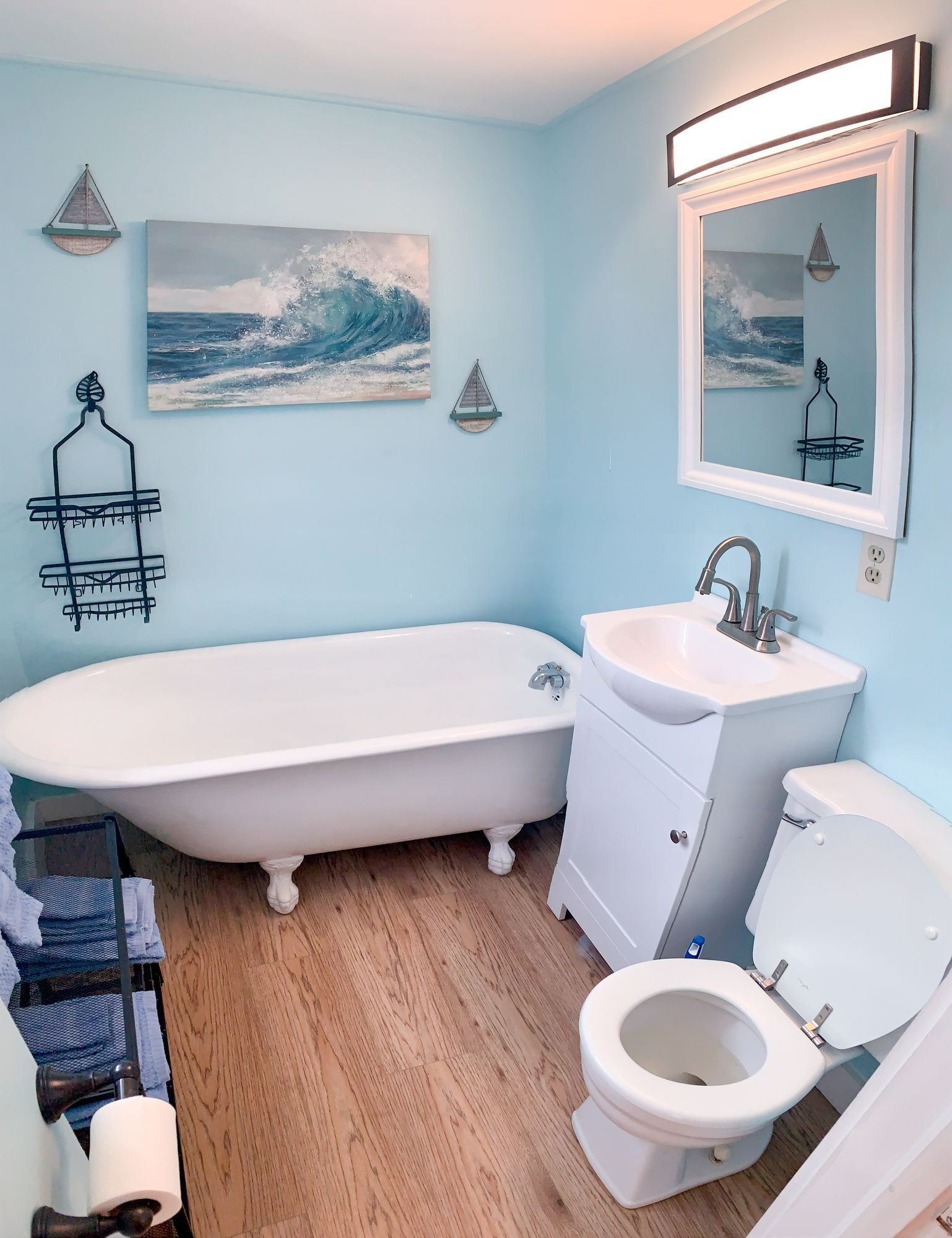 A bathroom with a tub a sink and a toilet