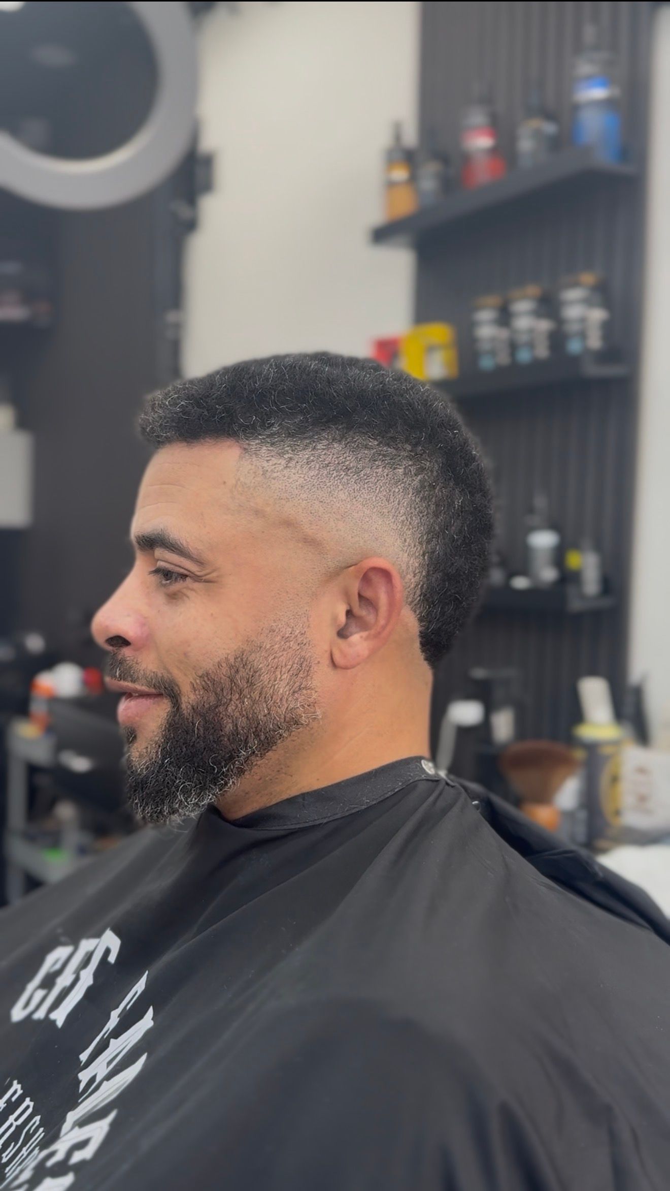 Craft Fades barbershop logo with gold CF monogram on dark textured background