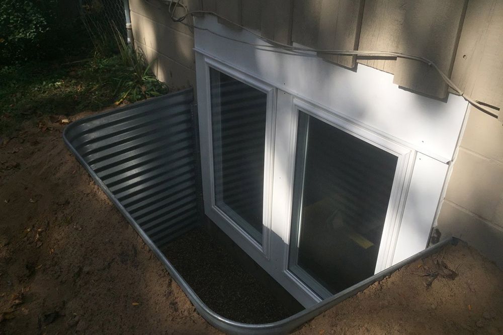 There is a window in the basement of a house.