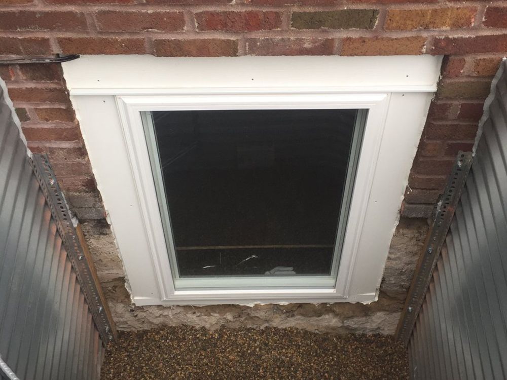 A window in the corner of a brick building.