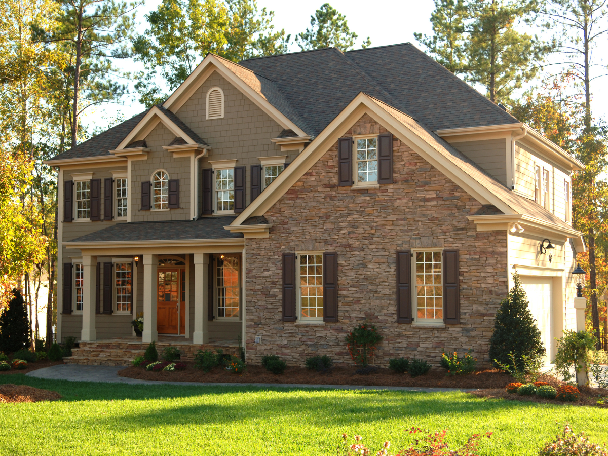 A row of houses with white garage doors and windows. A row of houses with white garage doors and windows.