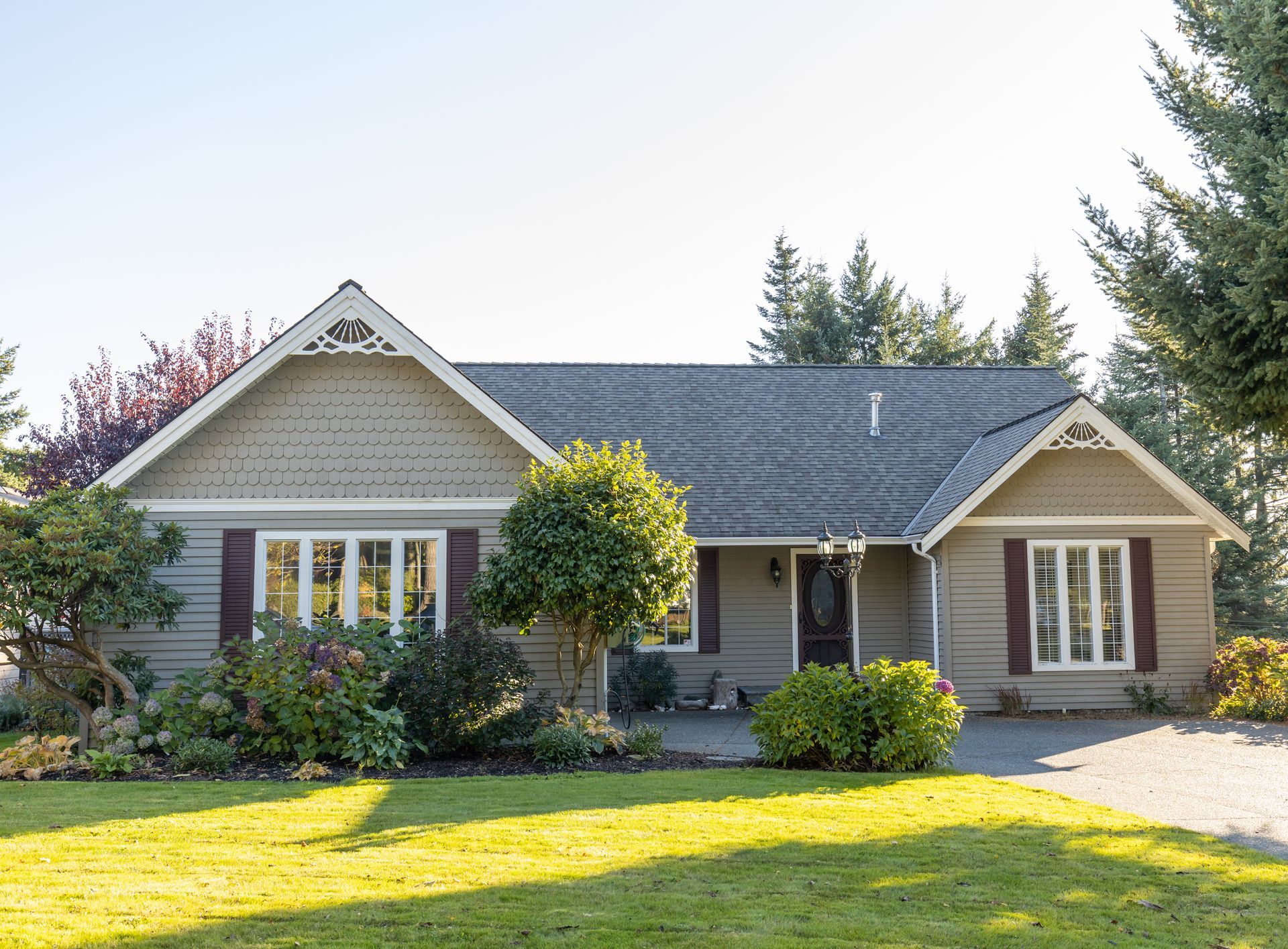 Large brick house with green lawn, blue sky, and trees. Large brick house with green lawn, blue sky, and trees.