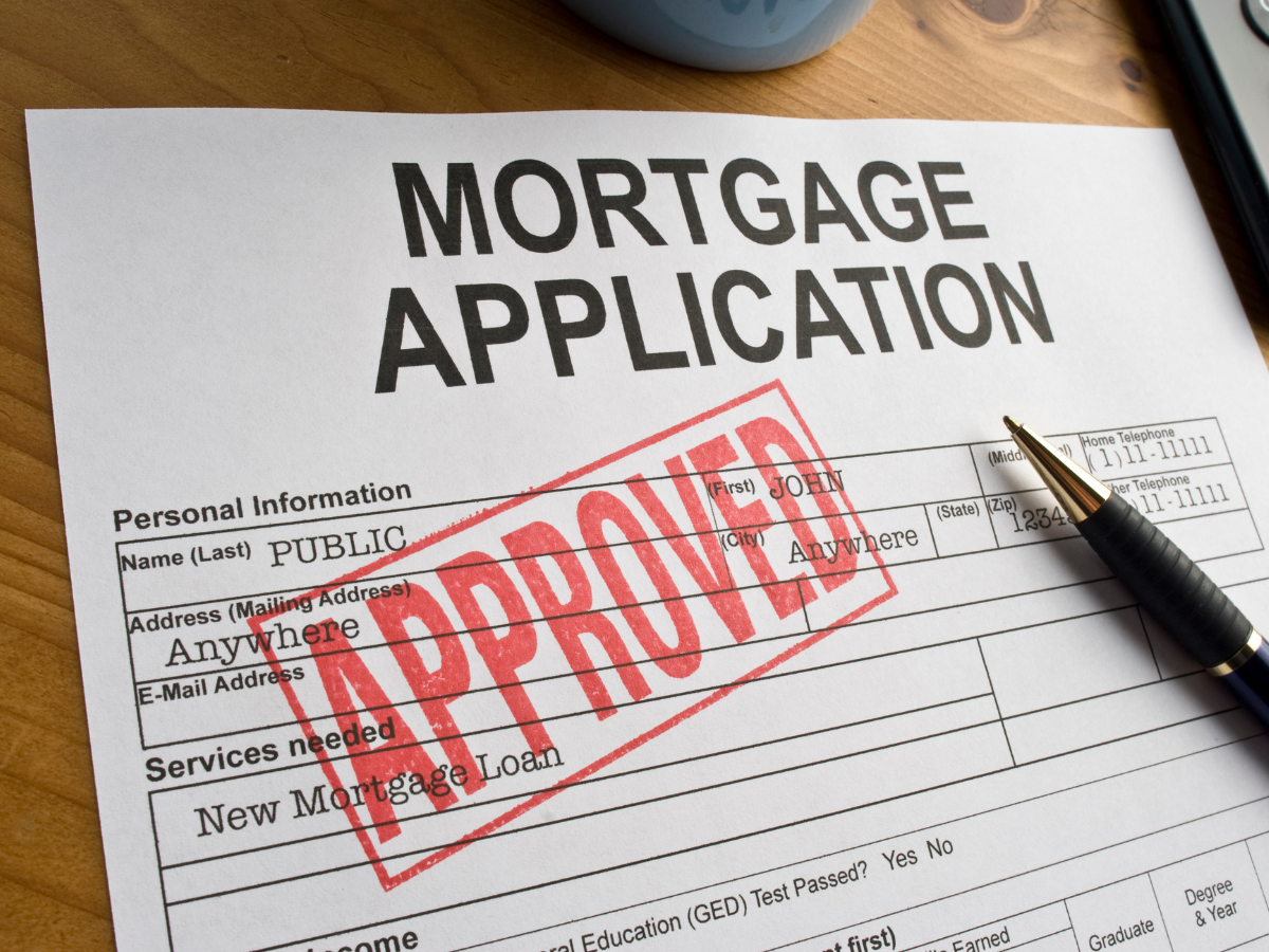 A mortgage application has been approved with a pen on it