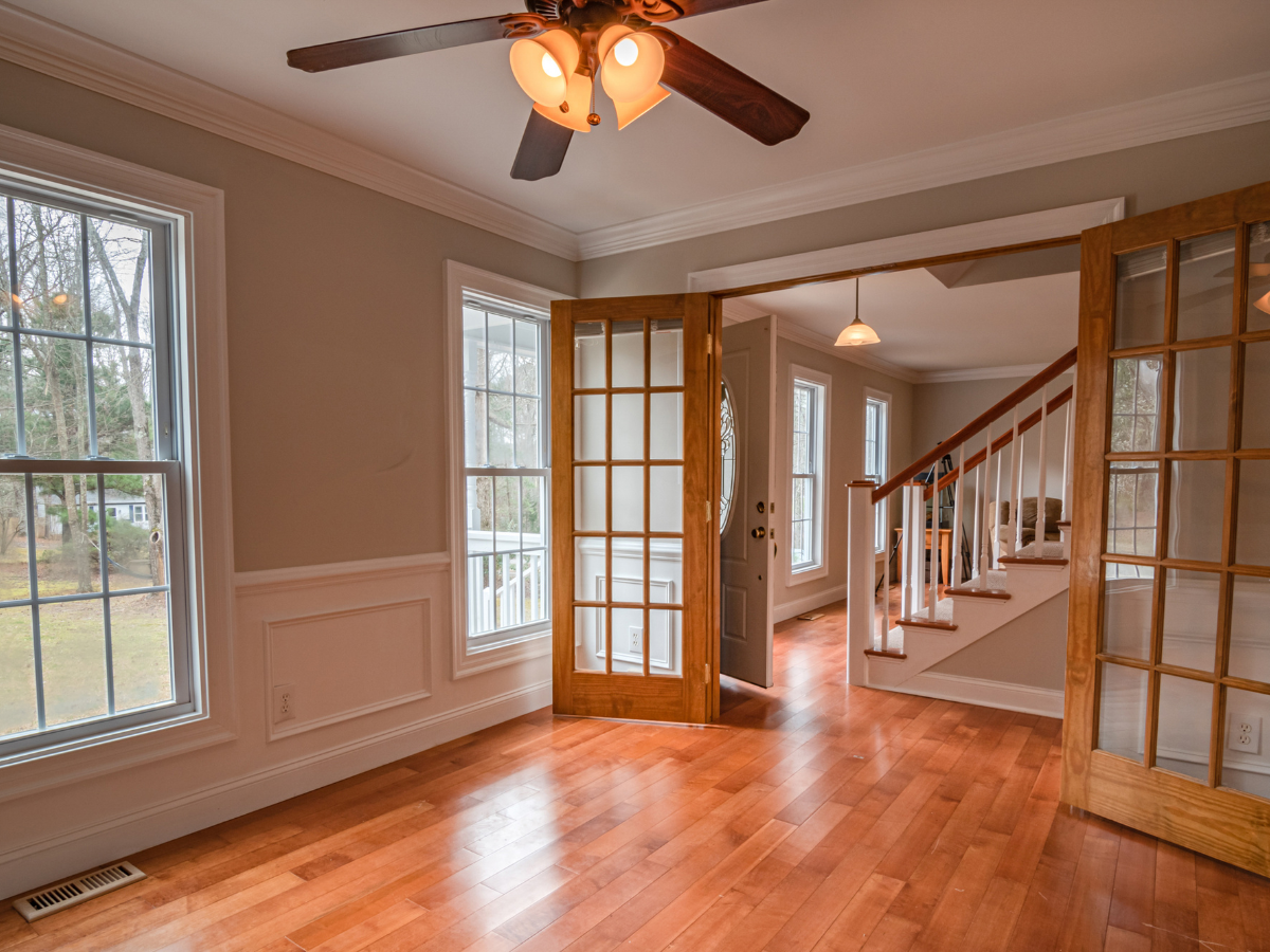 An empty room with hardwood floors and a ceiling fan. An empty room with hardwood floors and a ceiling fan.