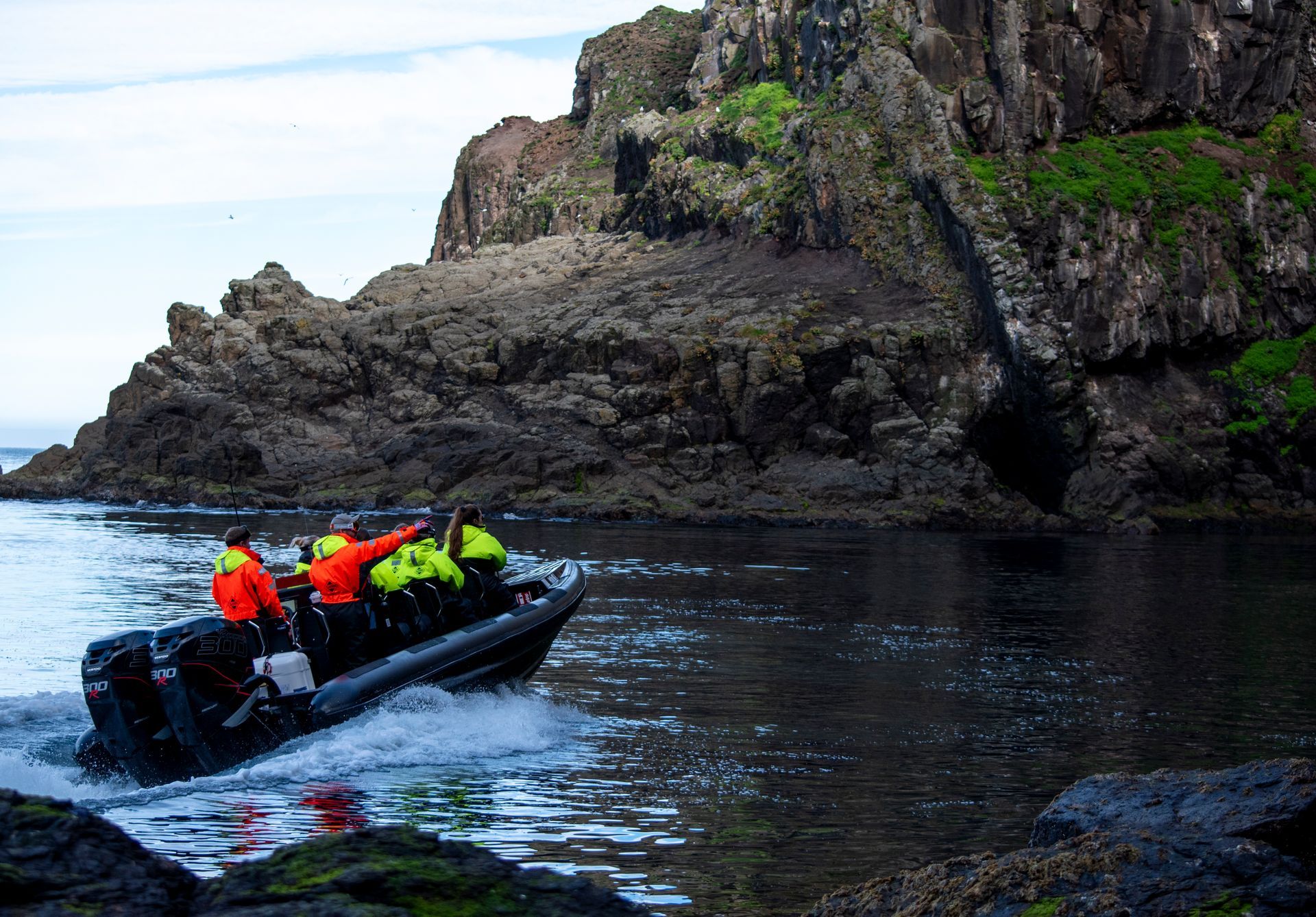 Tourists enjoying a RIB boat ride with breathtaking views of East Iceland