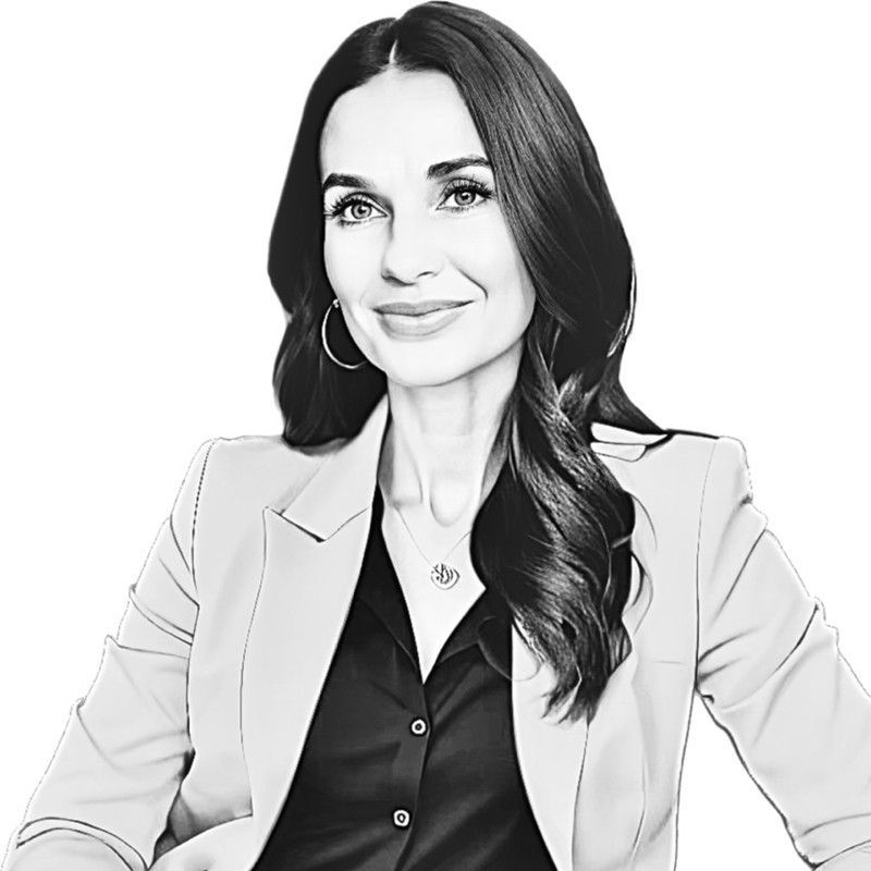 A black and white photo of a woman wearing a jacket and a black shirt.