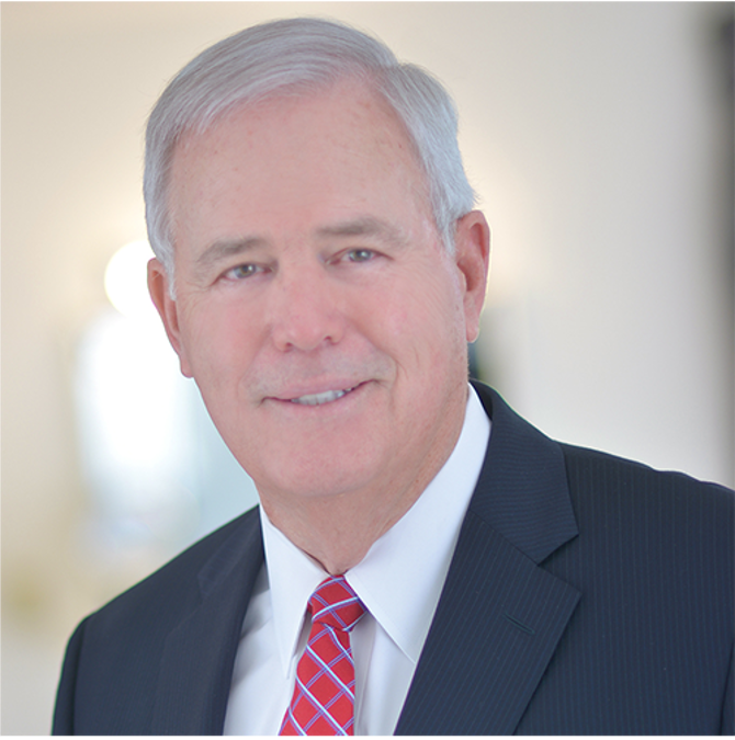 A man in a suit and tie smiles for the camera