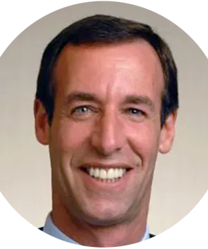 A man in a suit and tie is smiling in a circle.